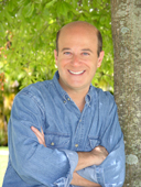 Steve Greenberg headshot, leaning on tree